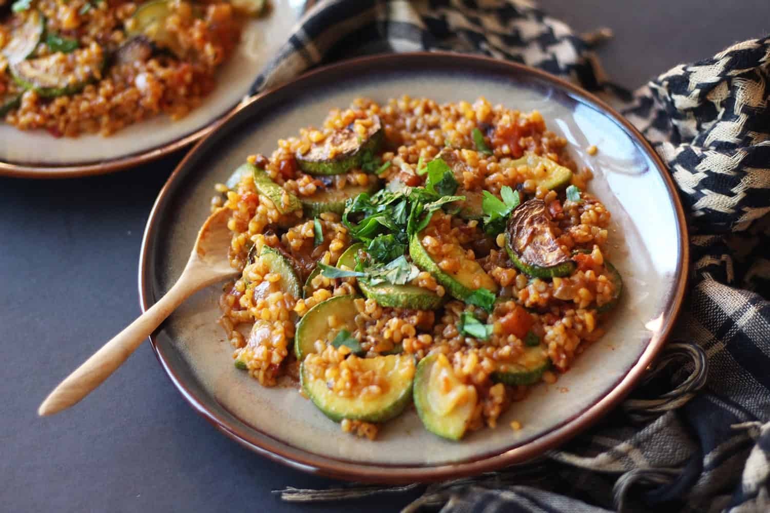 Zucchini and bulgur bake, golden brown and bubbling, served in a rustic dish