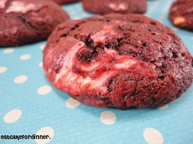 vibrant red velvet cookies with white cream cheese swirl, dramatically presented