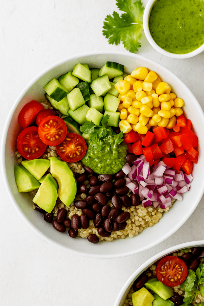 vibrant quinoa black bean bowl garnished with avocado cilantro and lime