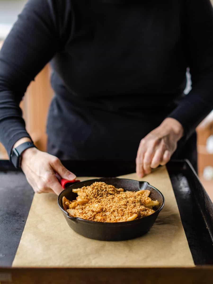 Father and child cooking apple crisp on an outdoor griddle