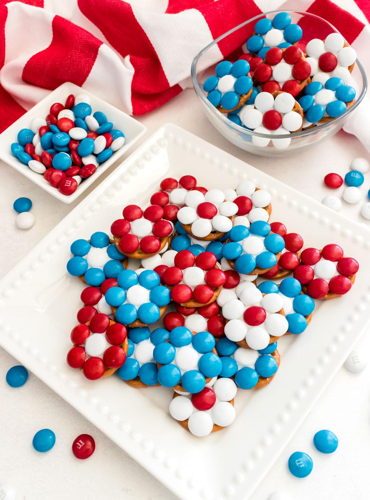 close up of firecracker pretzel bites on a plate, colorful candy melts