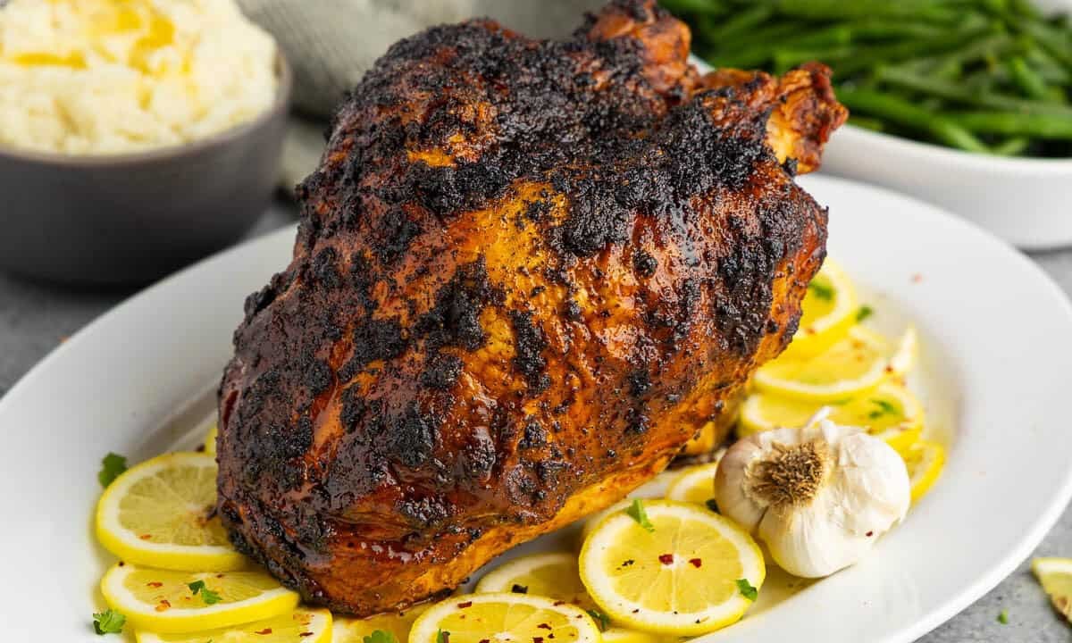 Close-up pan-seared turkey breast with lemon slices and butter sauce