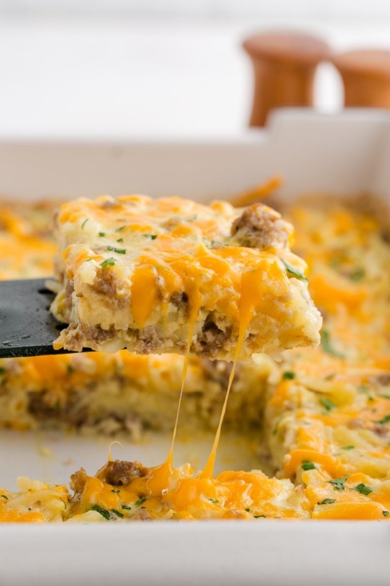 hearty sausage egg casserole baking in a cast iron pan, steam rising, golden brown top, delicious breakfast